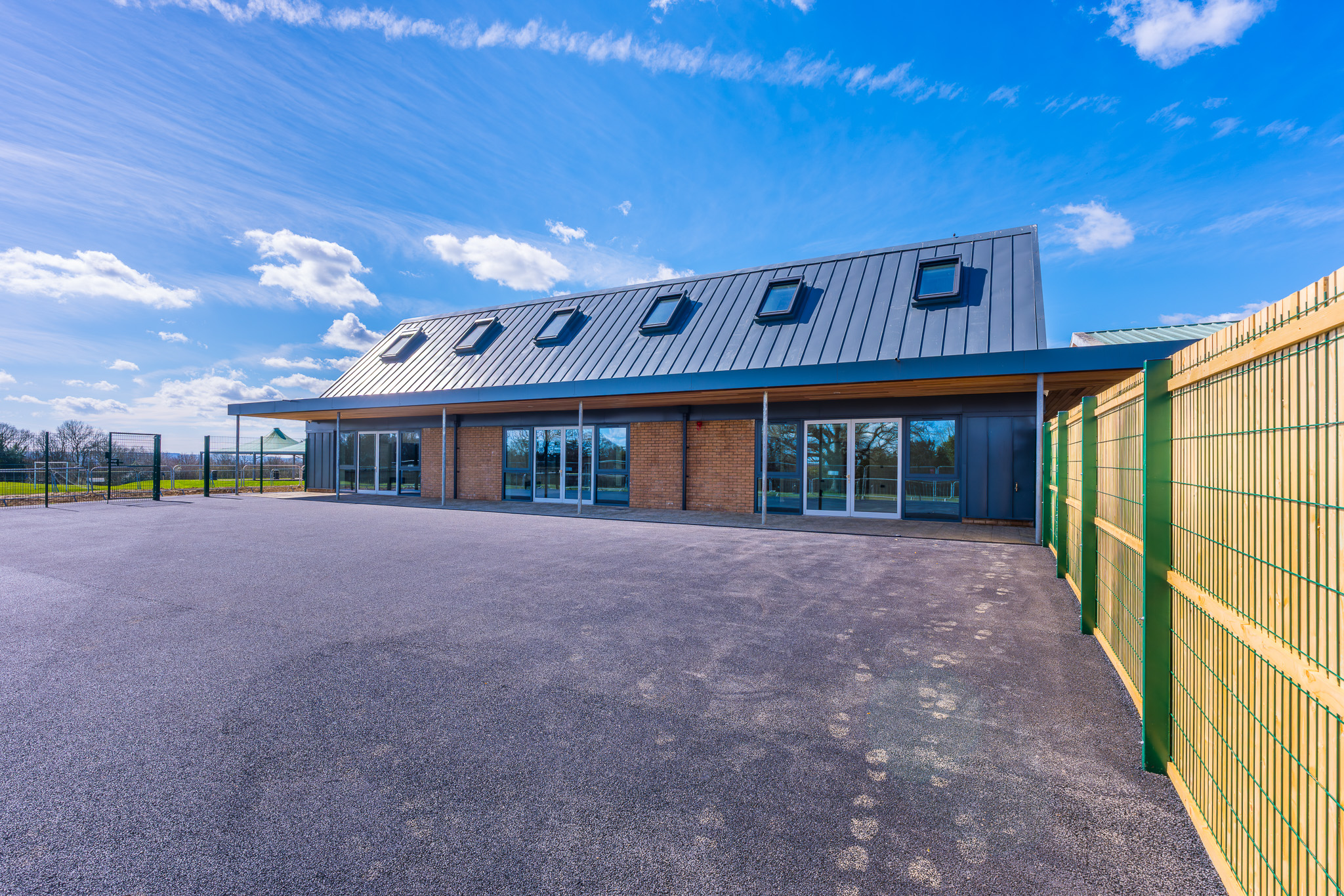 New SEND school extension at Warden Park School showing modern single-storey building with pitched roof, skylights and accessible entrance, designed to support students with special educational needs and disabilities.