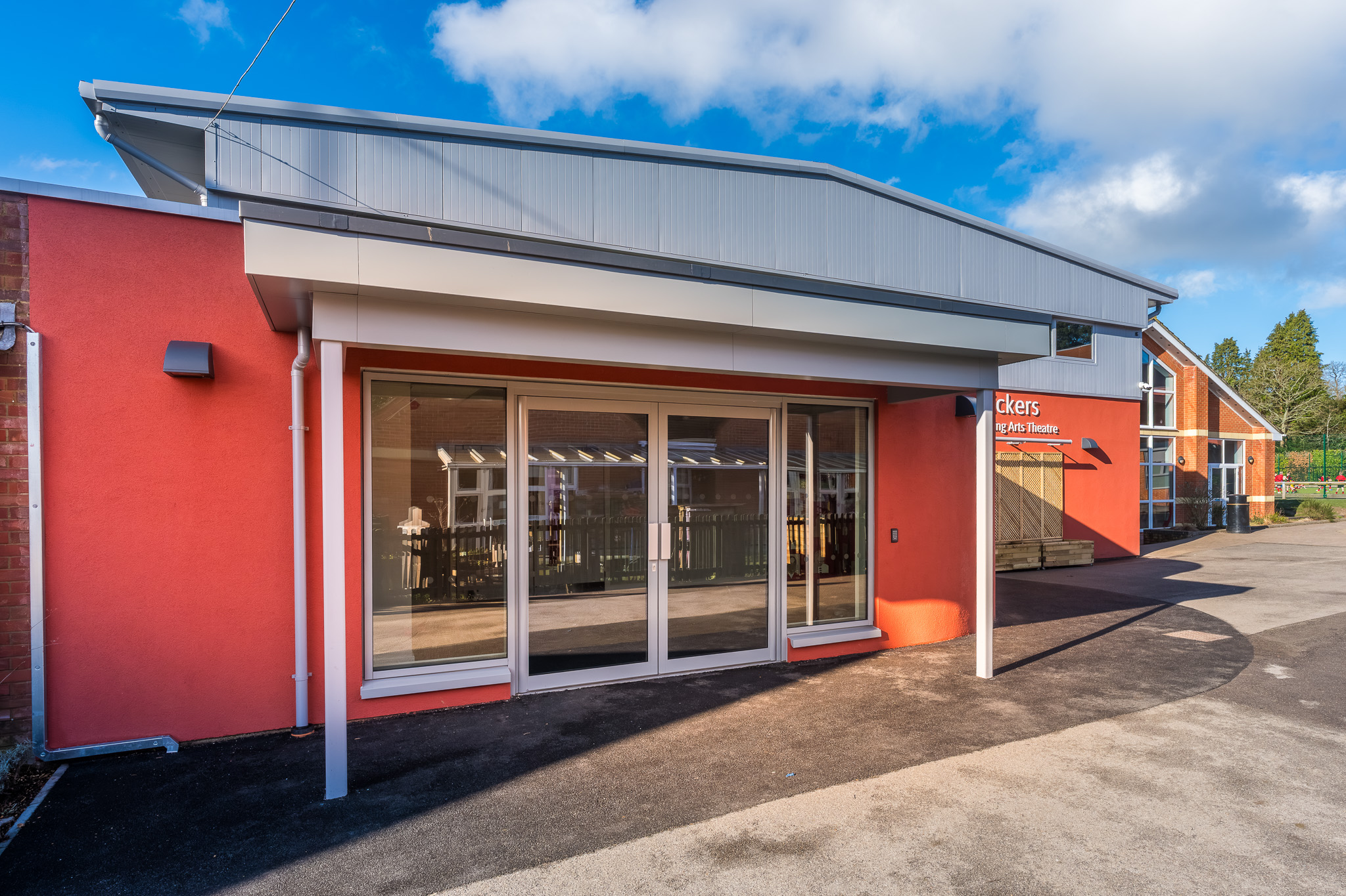 Exterior of newly refurbished Vickers Hall at Bishopsgate Prep School, featuring upgraded entrance, façade and glazing.